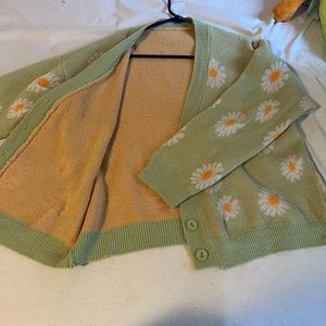 Green cardigan with flowers.